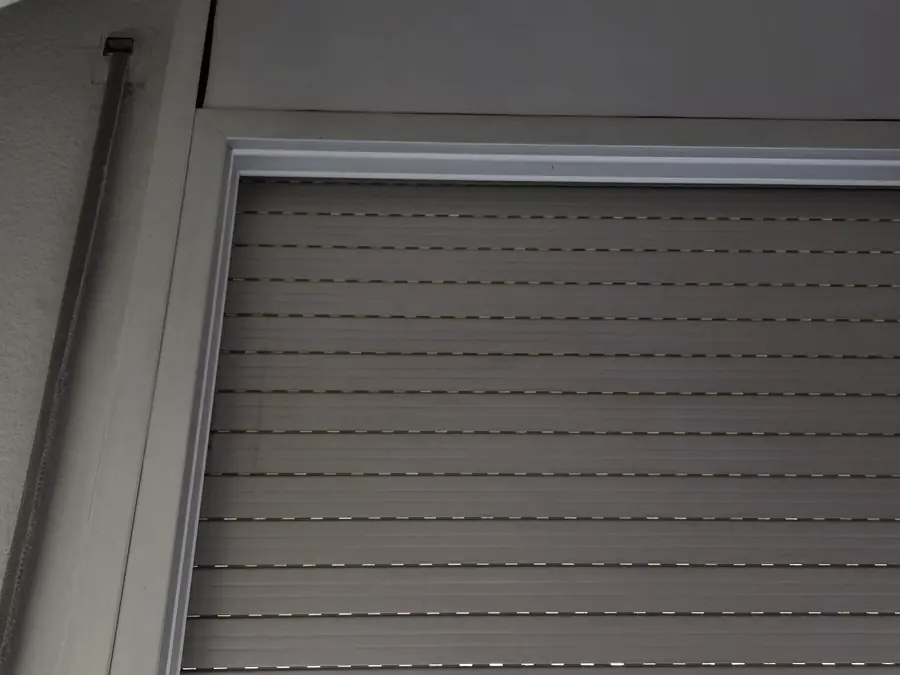 Stuck or misaligned roller shutter on a window before repair